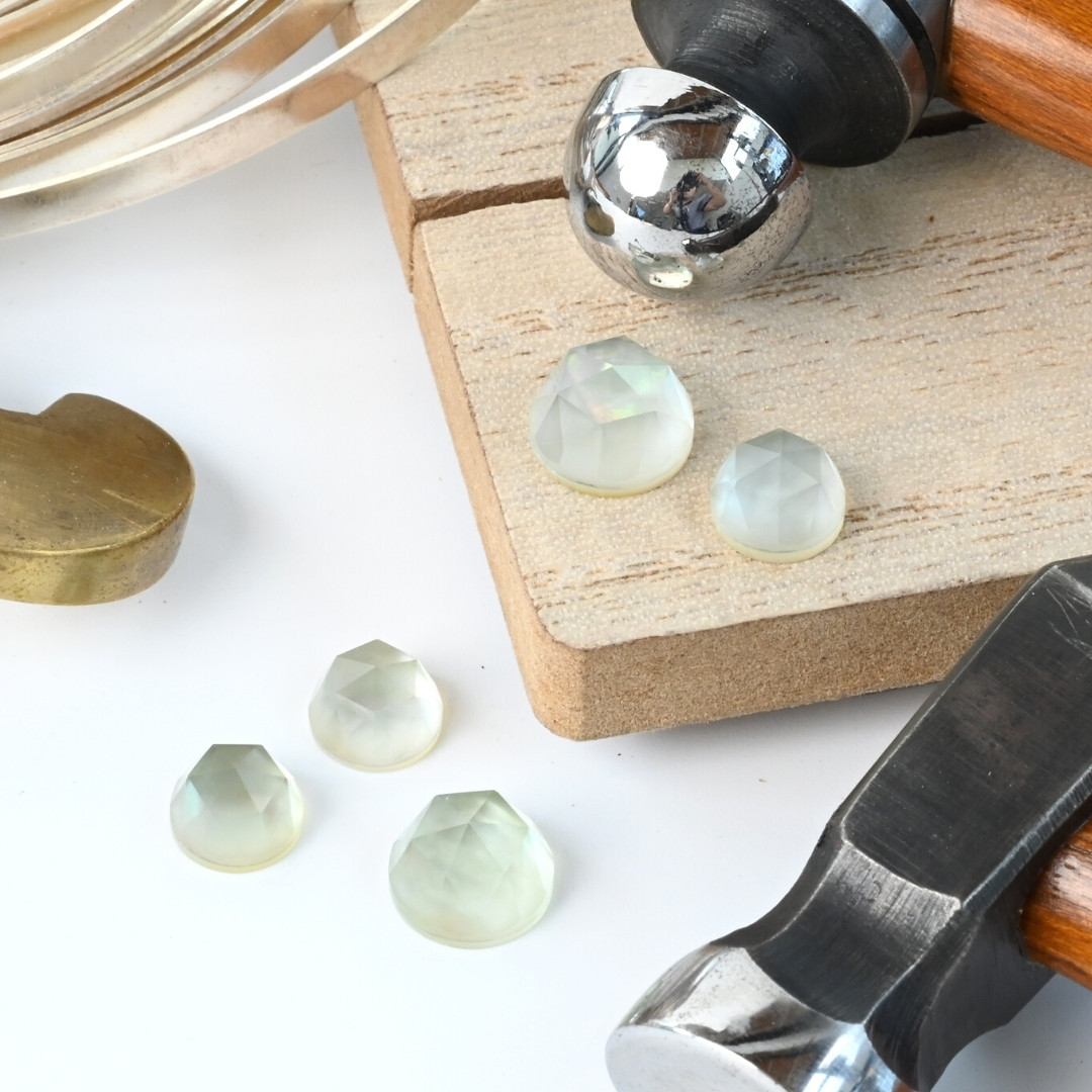 Green amethyst and mother of pearl doublets