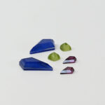 Lapis and quartz kite cut doublets, peridot and mother of pearl sugarloaf doublets and rhodolite garnet kite cuts