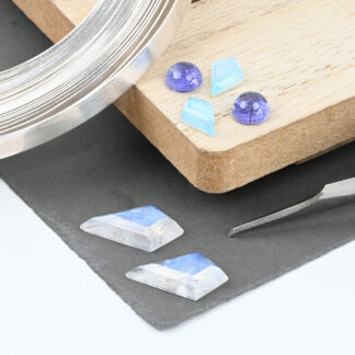 Collection of kite cut moonstones, tanzanite cabochons and blue topaz kite cuts
