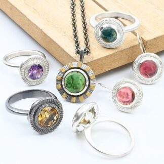 Selection of hand made bezel set silver jewelry